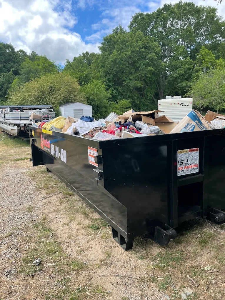 Dumpster loaded with cleanout debris