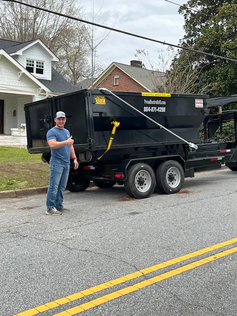 A member of the Proudfoot Rolloffs crew beside the roll-off truck